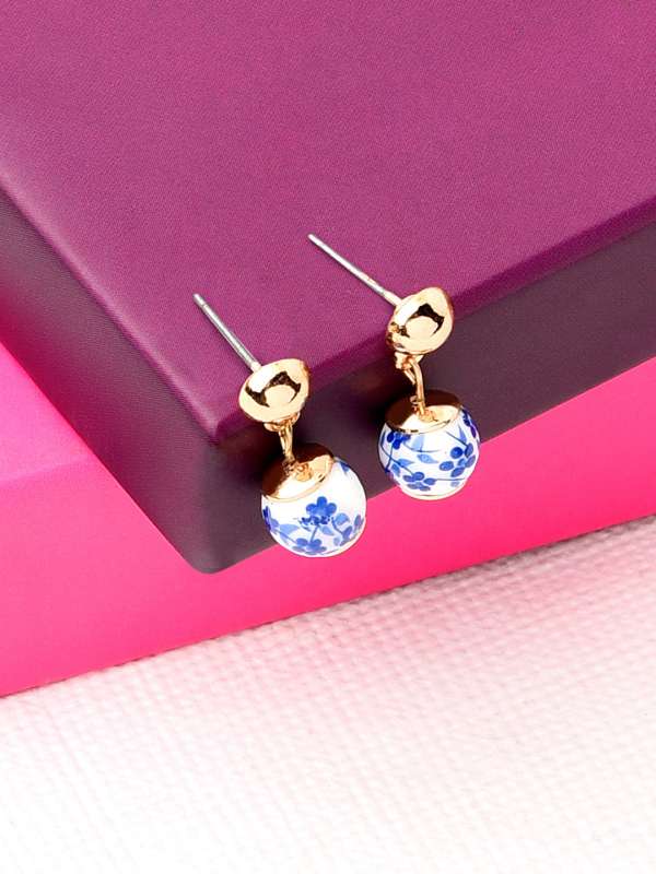 Blue earrings accessorize top