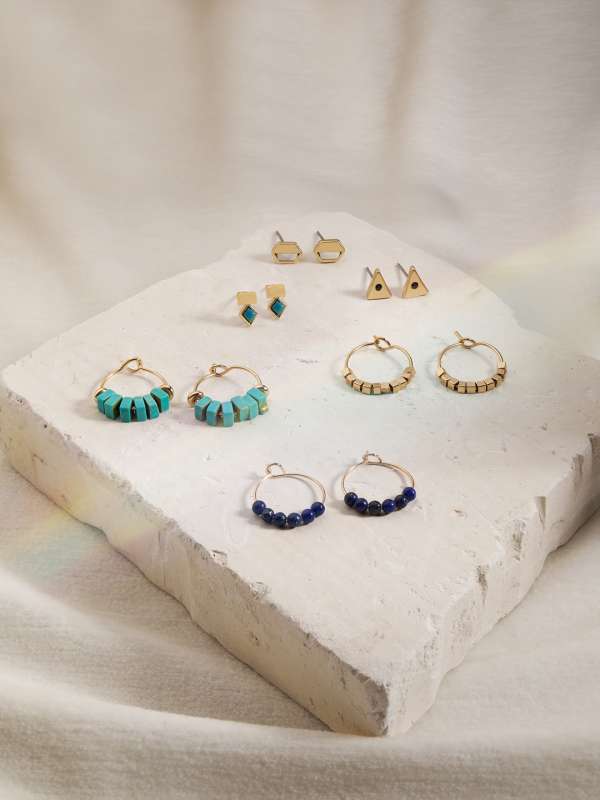 Blue earrings accessorize top
