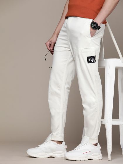 Buy Calvin Klein Jeans Men Grey Solid Tapered Fit Trousers