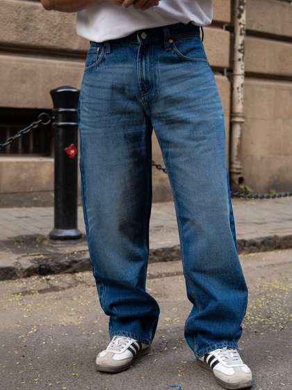 Powerlook Men
                          Relaxed Fit Mid-Rise Mildly Distressed Light
                          Fade Jeans