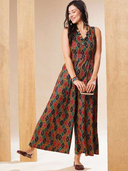 Globus Ethnic Gold
                        Foil Printed Wrap Neck Belted Flared Leg Fusion
                        Jumpsuit