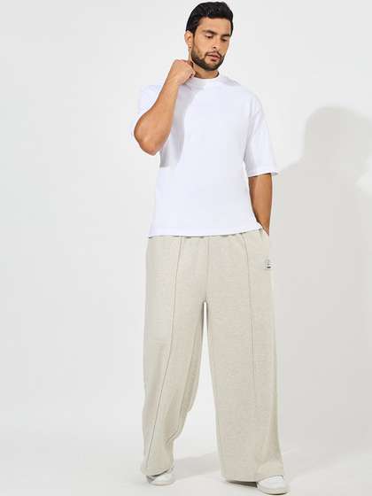 Styli Men Cream
                        Coloured Solid Flared Fit Cotton Track Pants