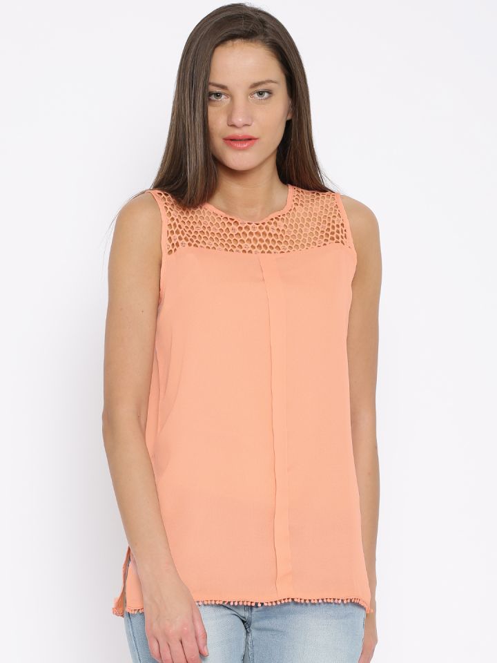 peach color top with jeans