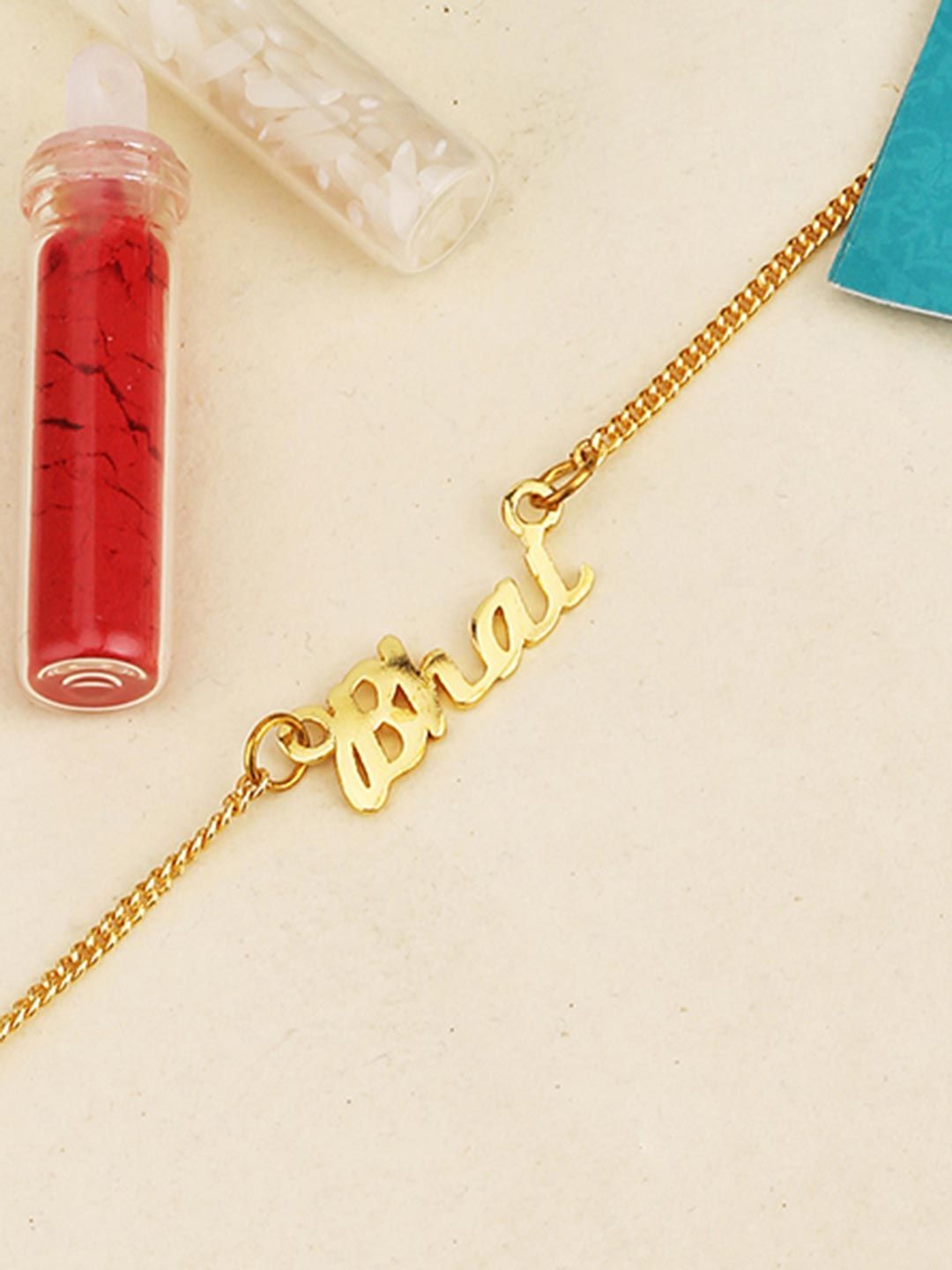 Gold-Toned Rakhi Bracelet Engraved with The Word 'Bhai' with Roli Chaawal Pack