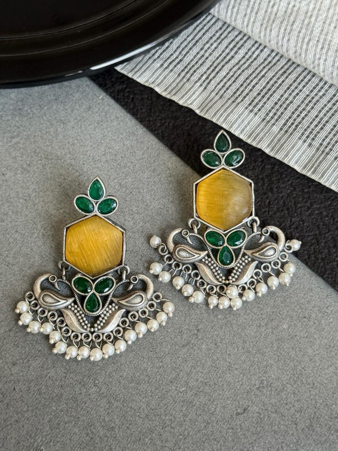 NAMAN ARTS Silver-Plated Stones Studded & Beaded Peacock Shaped Oxidized Drop Earrings