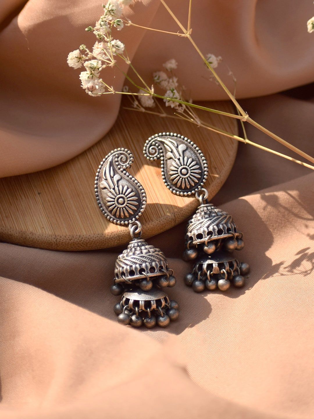 TEEJH Silver-Plated Paisley Shaped Jhumkas Earrings