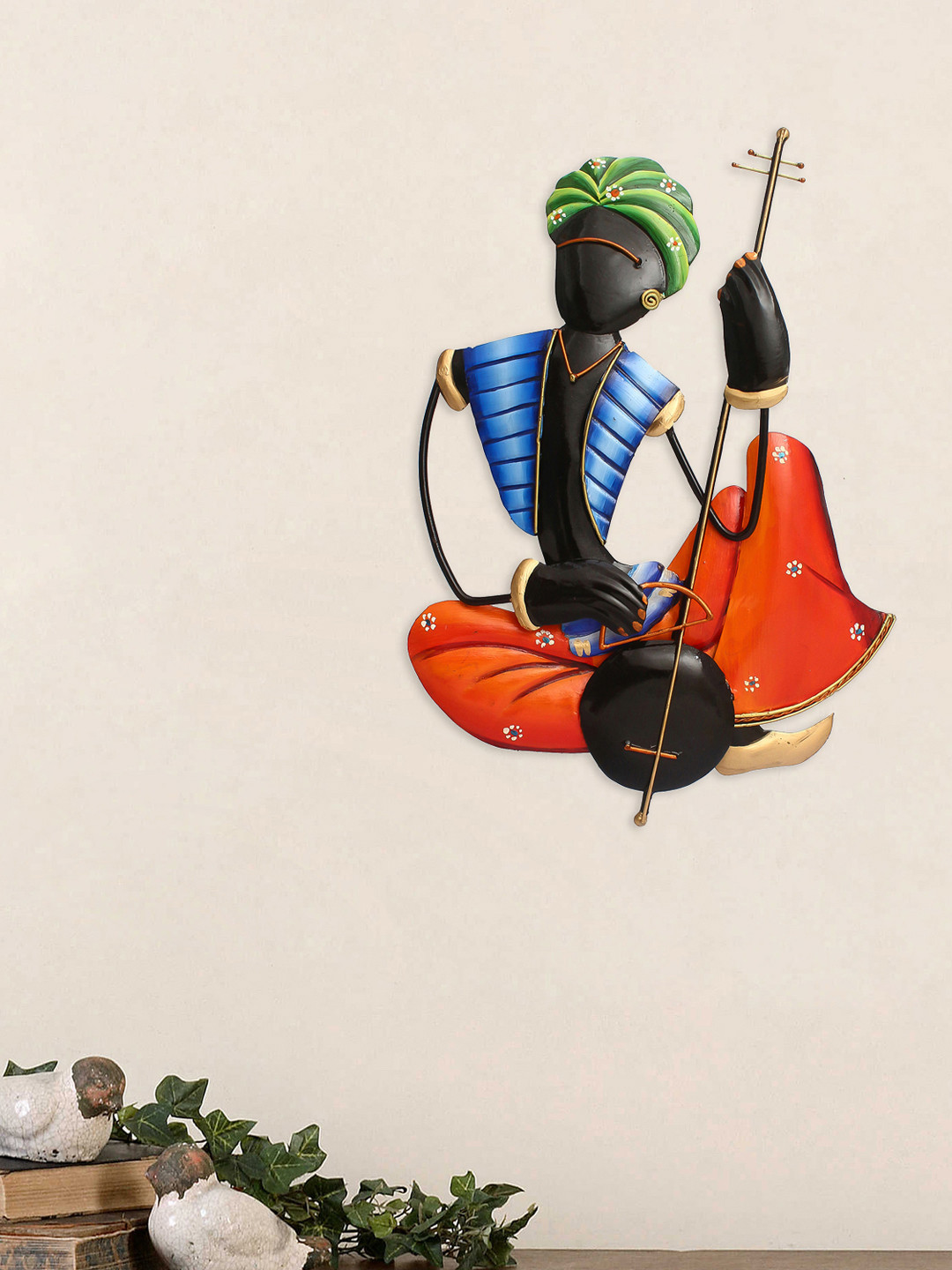 eCraftIndia Orange & Black Handcrafted Tribal Man Playing Veena Wall Hanging