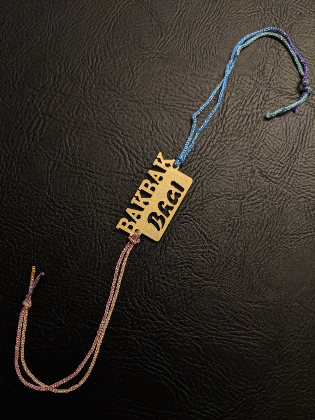 Digital Dress Room Gold-Toned Rakhi with BAKBAK BHAI Slogan