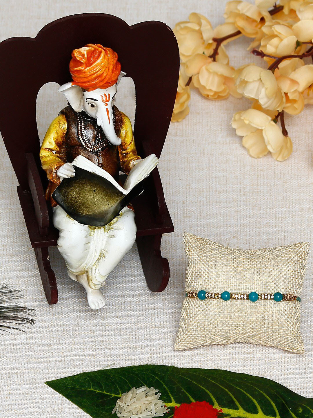 eCraftIndia Multicoloured Rakhi with Lord Ganesha Reading Book on Wooden Chair Gift Set