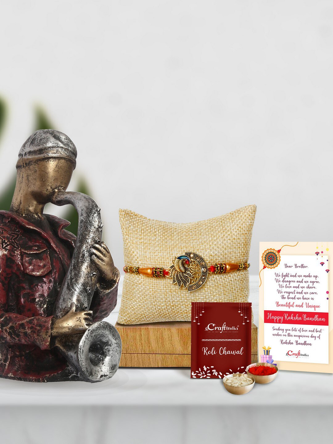 eCraftIndia Gold-Toned & Red Man with Hat Playing Trumpet Statue Rakhi Gift Set