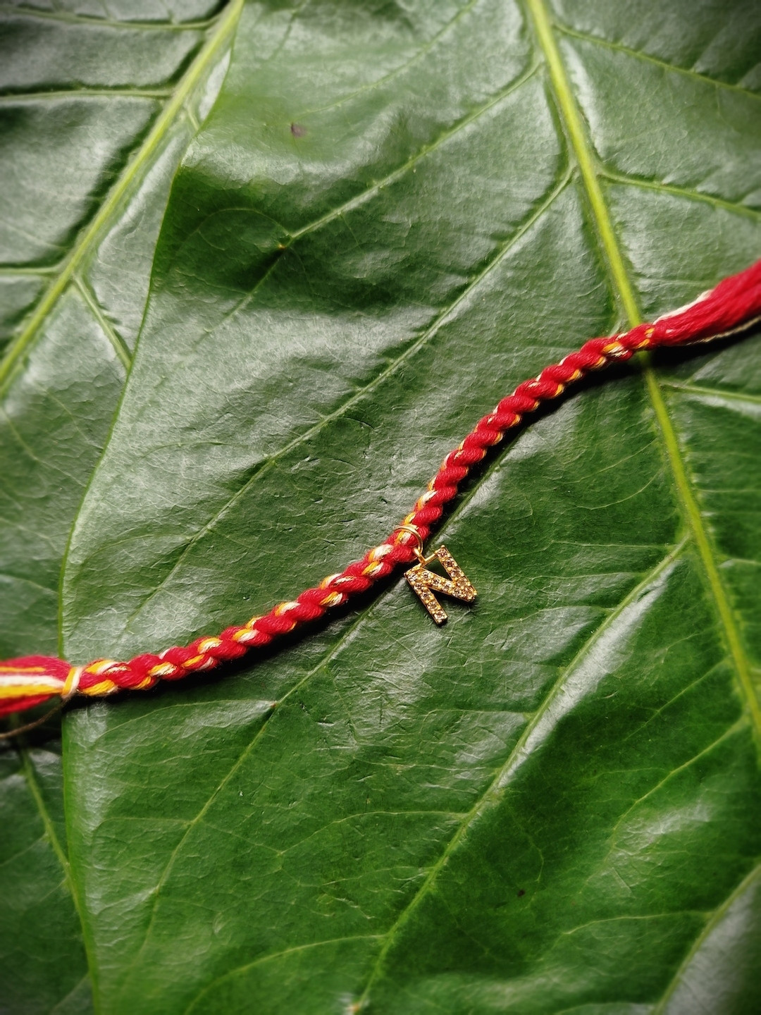 Digital Dress Room Gold-Plated Red & Yellow AD-Studded N Alphabet Customized Thread Rakhi