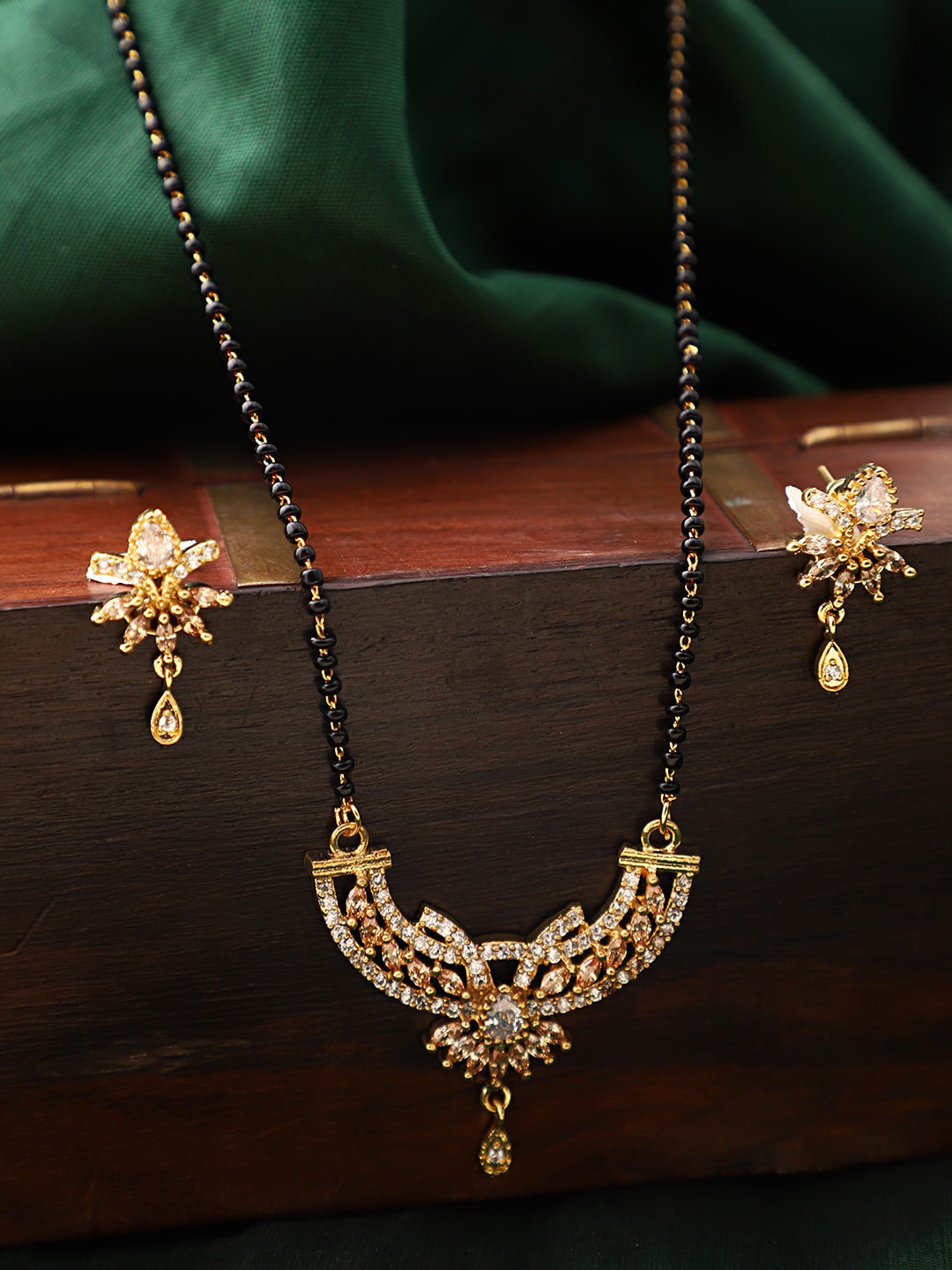 ANIKAS CREATION Gold-Plated Black & White Beaded & Stone-Studded Mangalsutra With Earrings