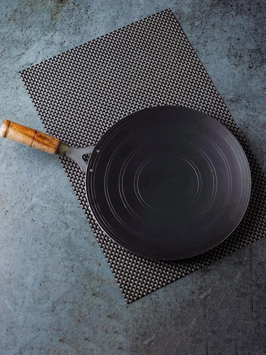 The Indus Valley Black Solid Pre-Seasoned Concave Iron Tawa with Wooden Handle