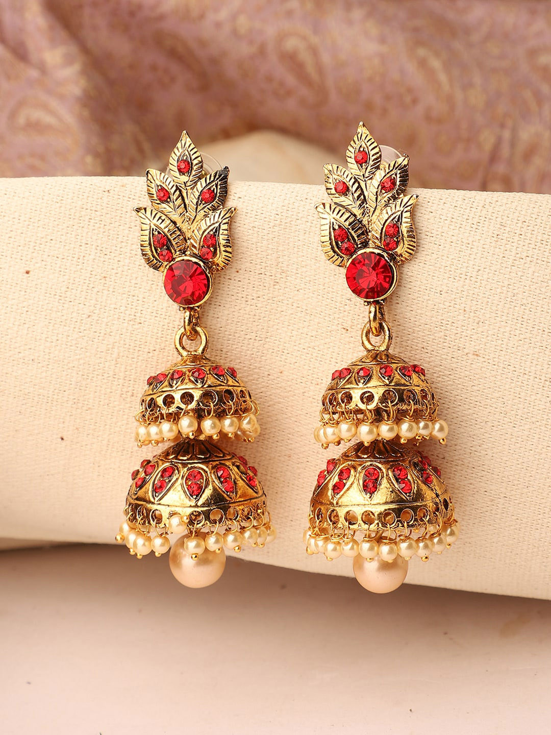 ANIKAS CREATION Red & Gold-Toned Leaf Motif Stone and Pearl Studded Jhumkas Earrings