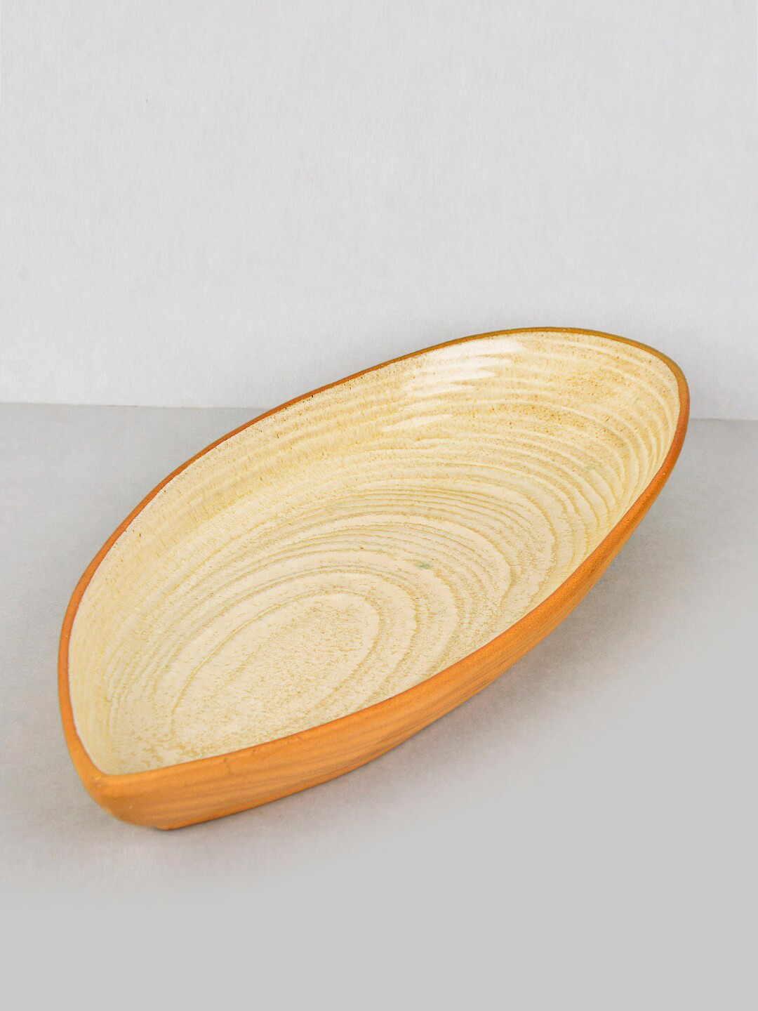 StyleMyWay Beige Solid Boat Shaped Ceramic Platter with Spiral Design