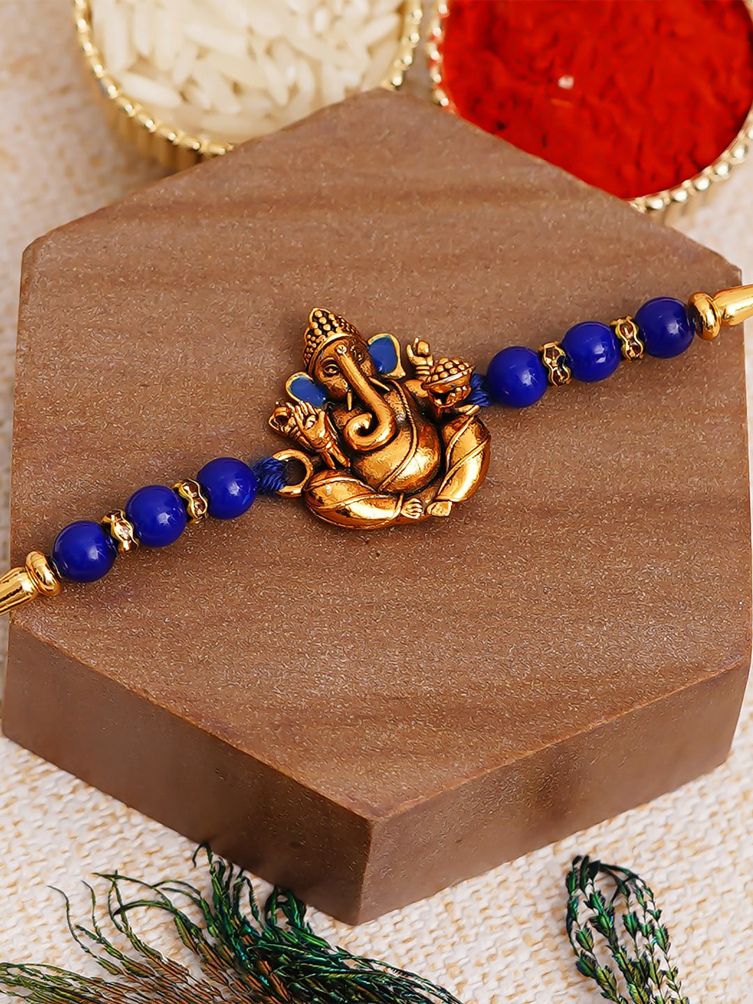 eCraftIndia Blue & Gold-Toned Lord Ganesha Pearl Rakhi with Roli Chawal
