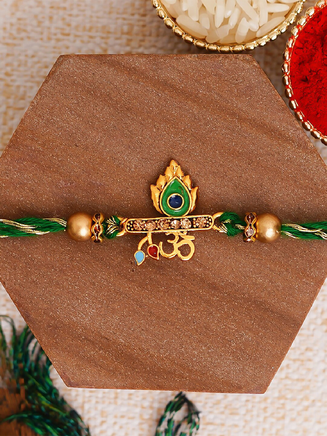 eCraftIndia Green Om & Peacock Feather Religious Rakhi with Roli Chawal
