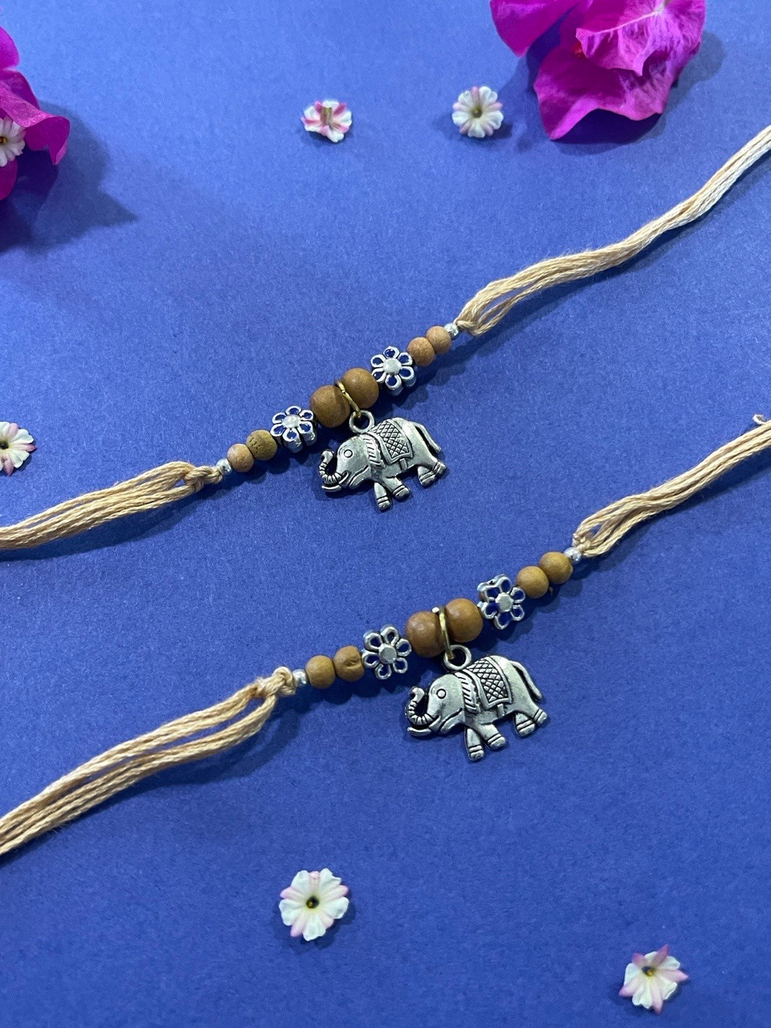 Digital Dress Room Men Set of 2 Cream & Silver Flower & Elephant Shaped Pendant Rakhi