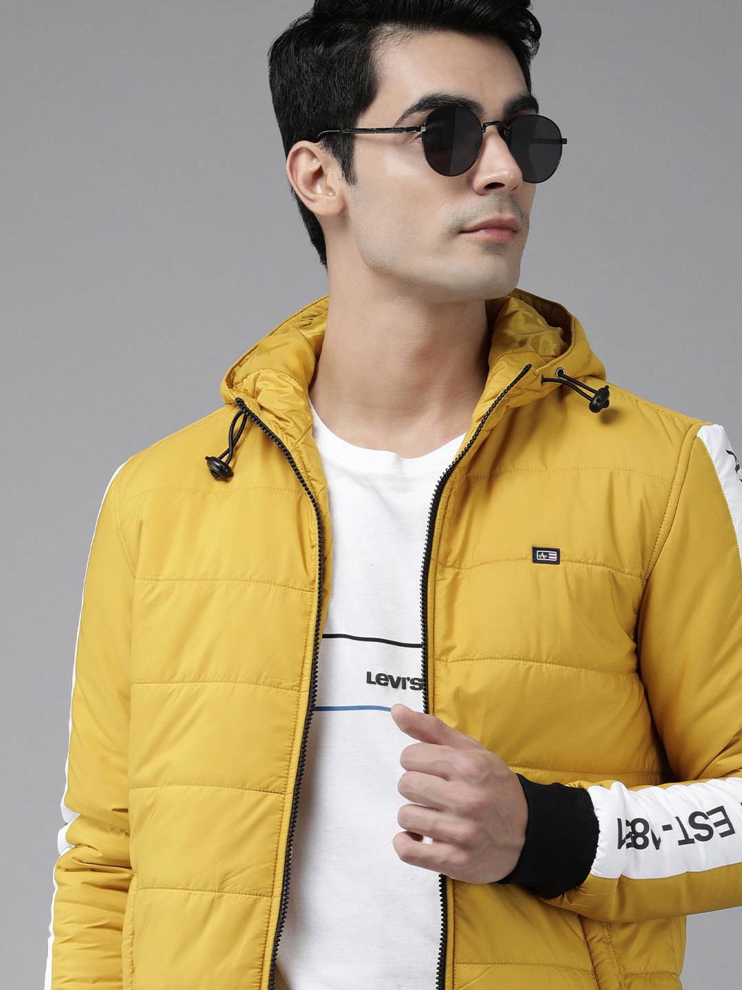 Arrow Men Yellow Solid Hooded Puffer Jacket with Striped & Printed Sleeves