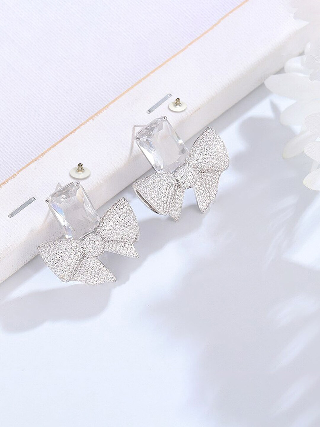 Yellow Chimes Silver-Toned Crystal Bow Knot Shape Stud Earrings