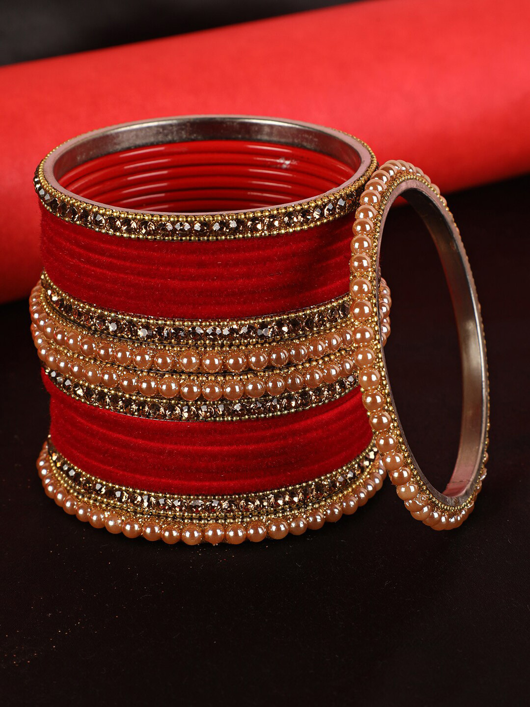 Jazz and Sizzle Set Of 24 Gold-Toned Red Stone-Studded Bangles