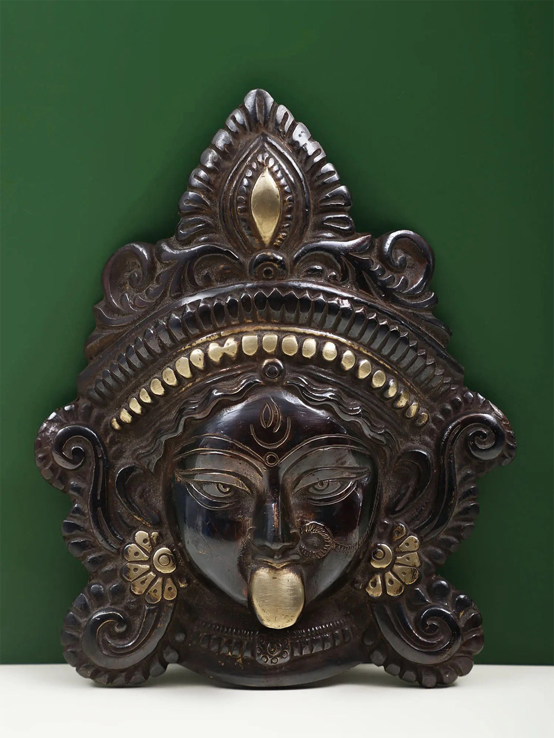 Exotic India Black & Gold Toned India The Serenity of Kali Mask Brass Wall Hanging