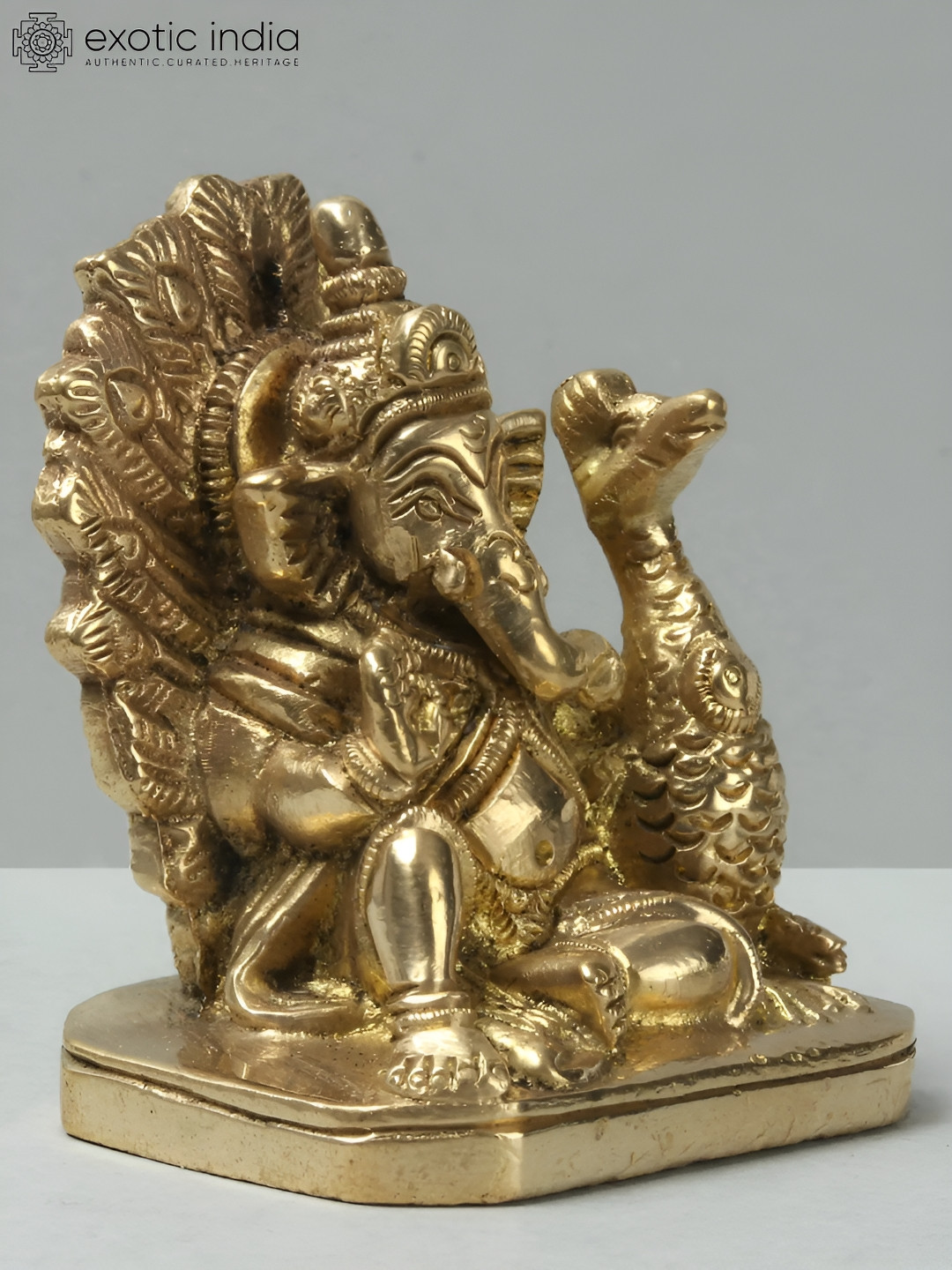 Exotic India Lord Ganesha Idol Seated with Peacock Gold Brass Metallic Prayer Room Small Showpiece - 2.2 Inches