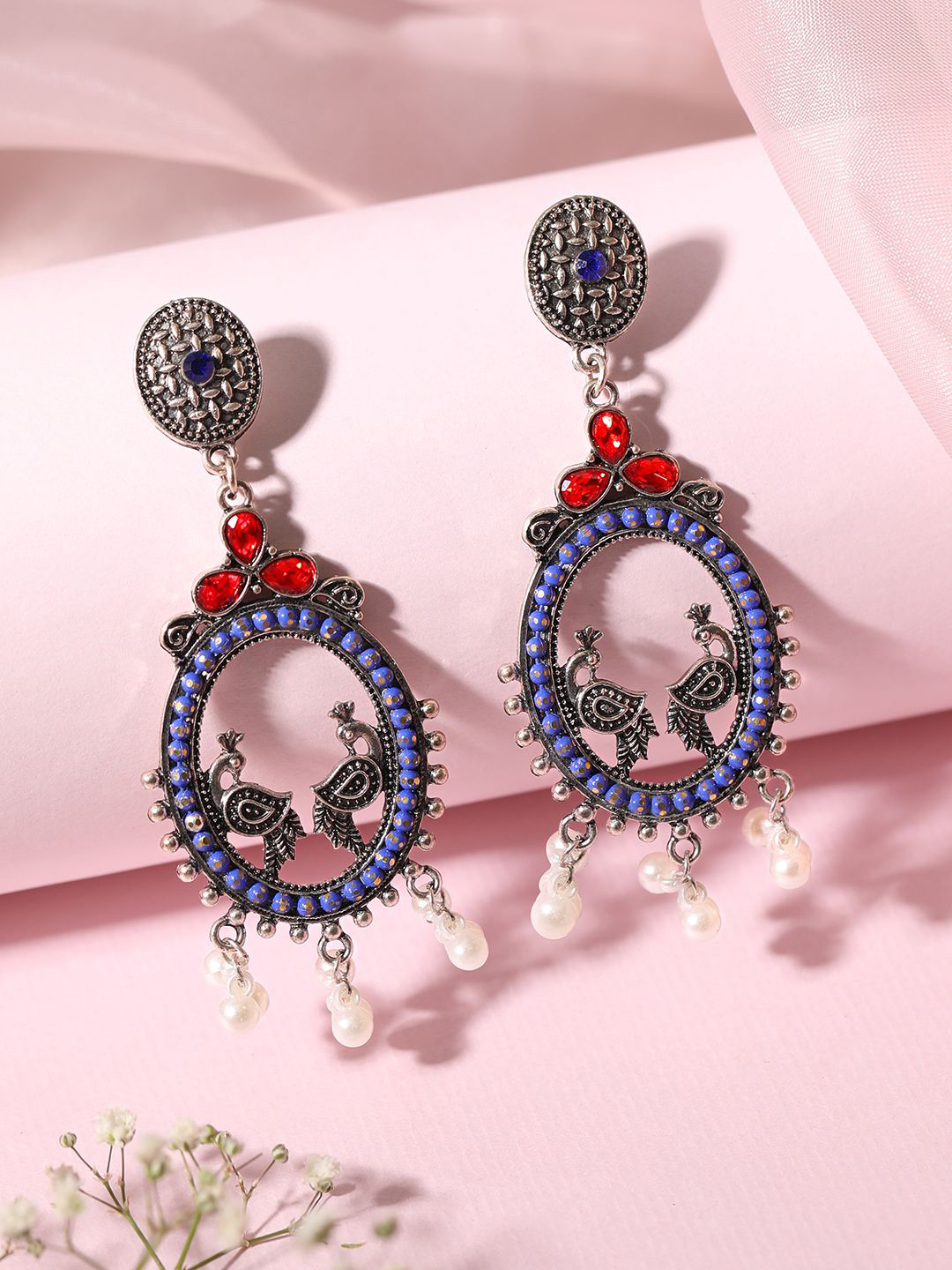 Rubans Oxidized Silver-Plated Oval Peacock Drop Earrings with Blue & Red AD & Pearl Beads