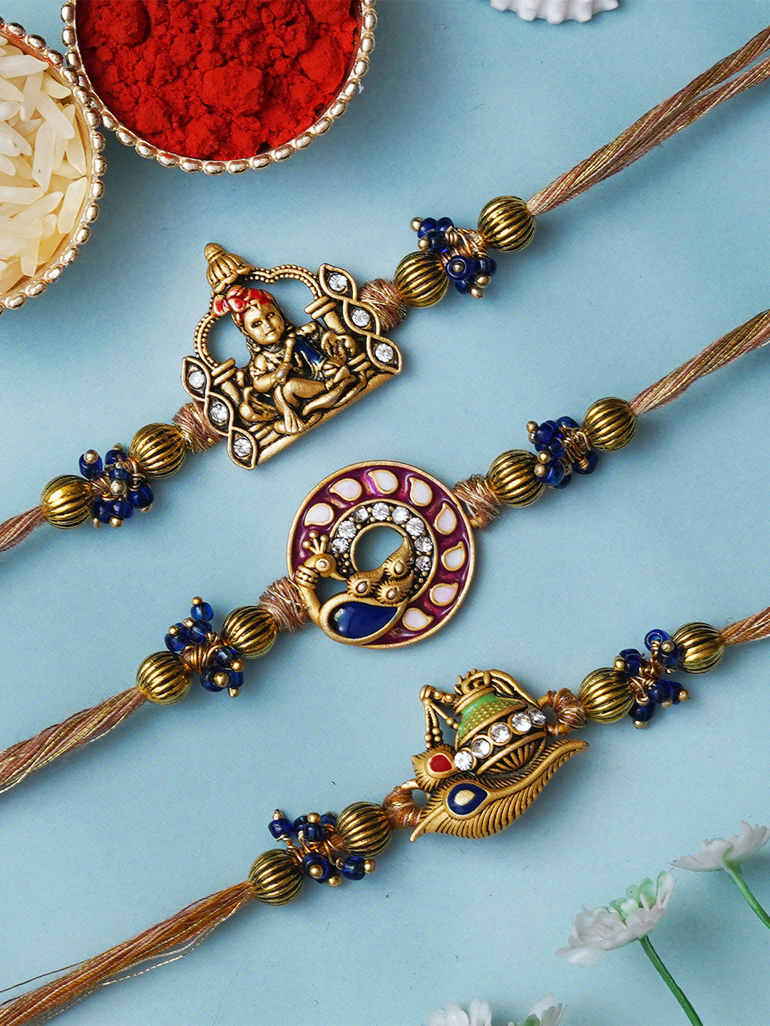 eCraftIndia Unisex Set of 3 Kalash Flute & Peacock Rakhis With Roli Chawal
