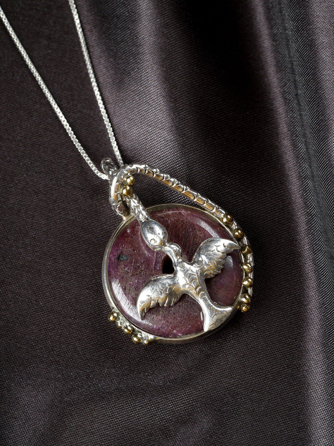 Exotic India Round Raw Ruby Sterling Silver Bird Pendant