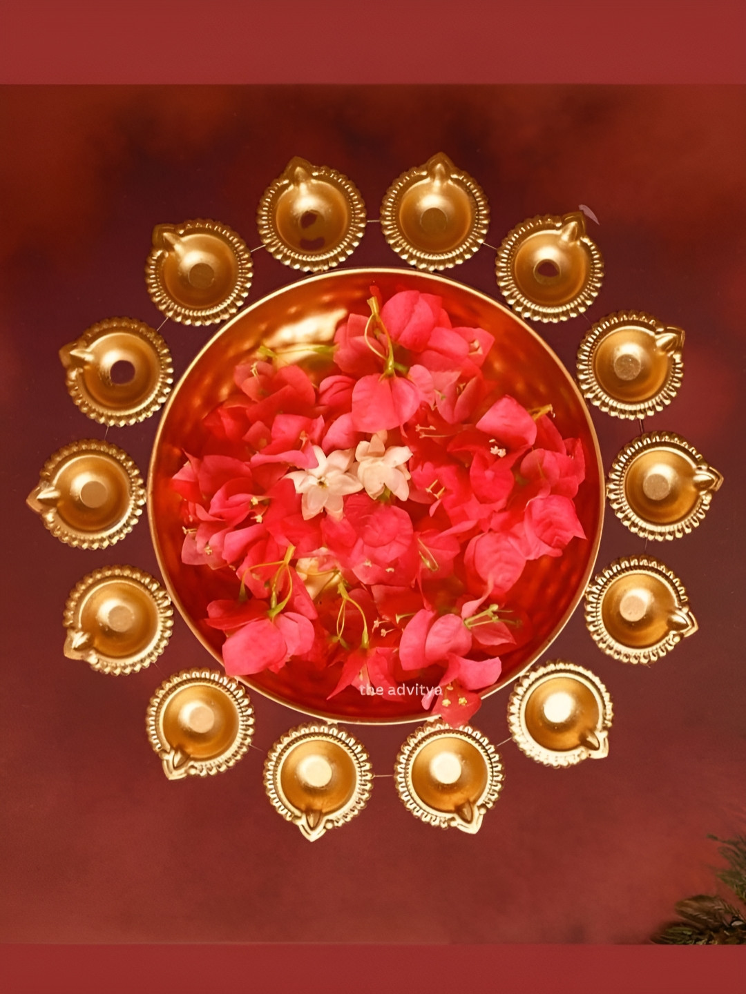 The Advitya Gold Toned Metal Urli Decorative Bowl With Diya