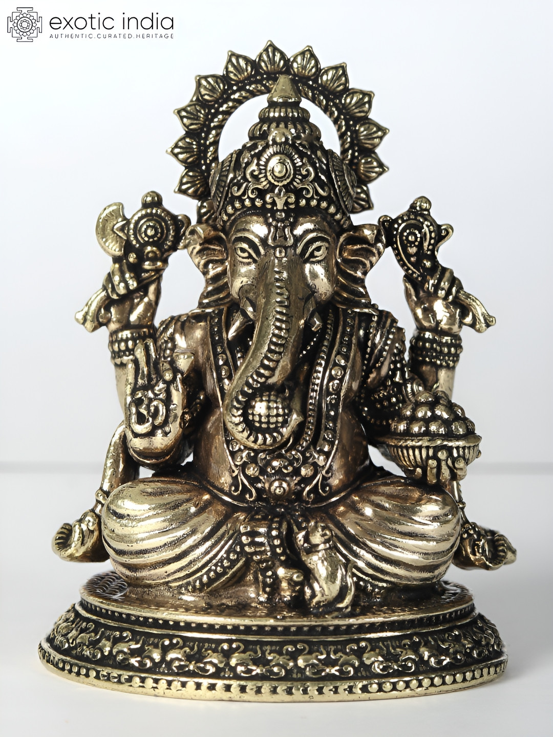 Exotic India Chaturbhuja Lord Ganesha with Laddu Gold Brass Metallic Prayer Room Tiny Showpiece - 1.8 Inches