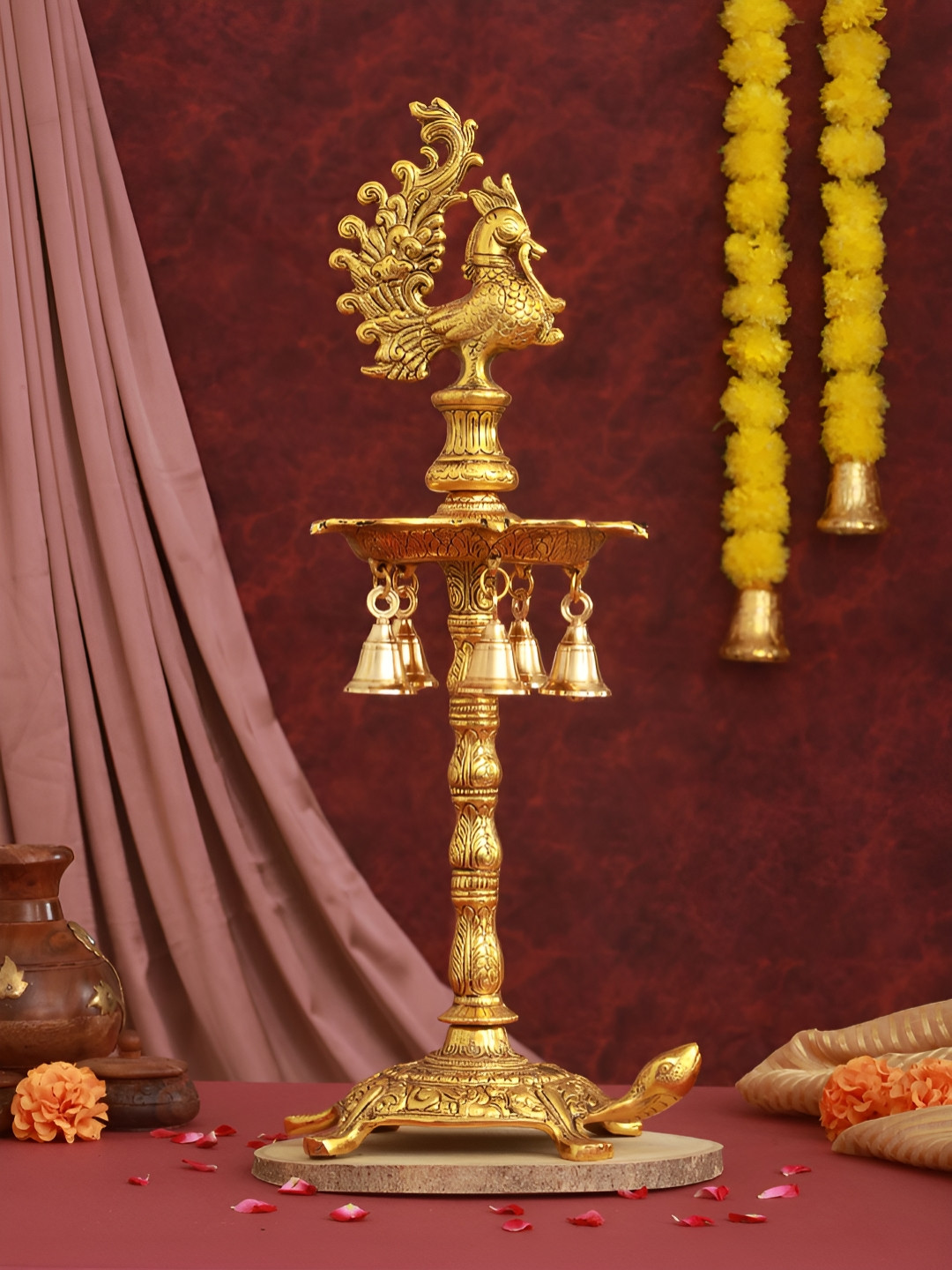 TIED RIBBONS Gold Toned Textured Peacock & Tortoise Diya Stand With Bells