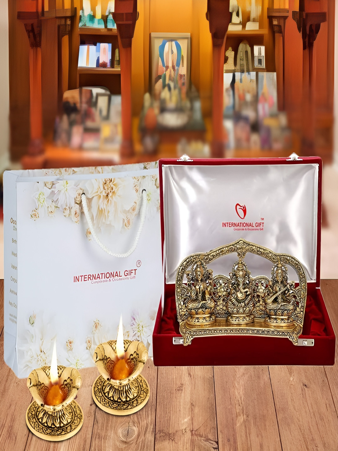 INTERNATIONAL GIFT Gold-Toned Lakshmi Ganesh Saraswati Idol with Diyas & Velvet Box