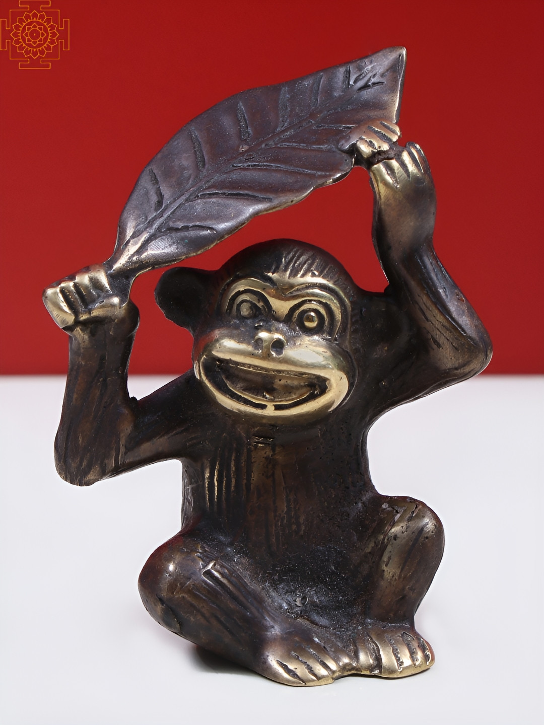 Exotic India Monkey Holding a Leaf Over Its Head Black Brass Metallic Living Room Tiny Showpiece - 3.3 Inches