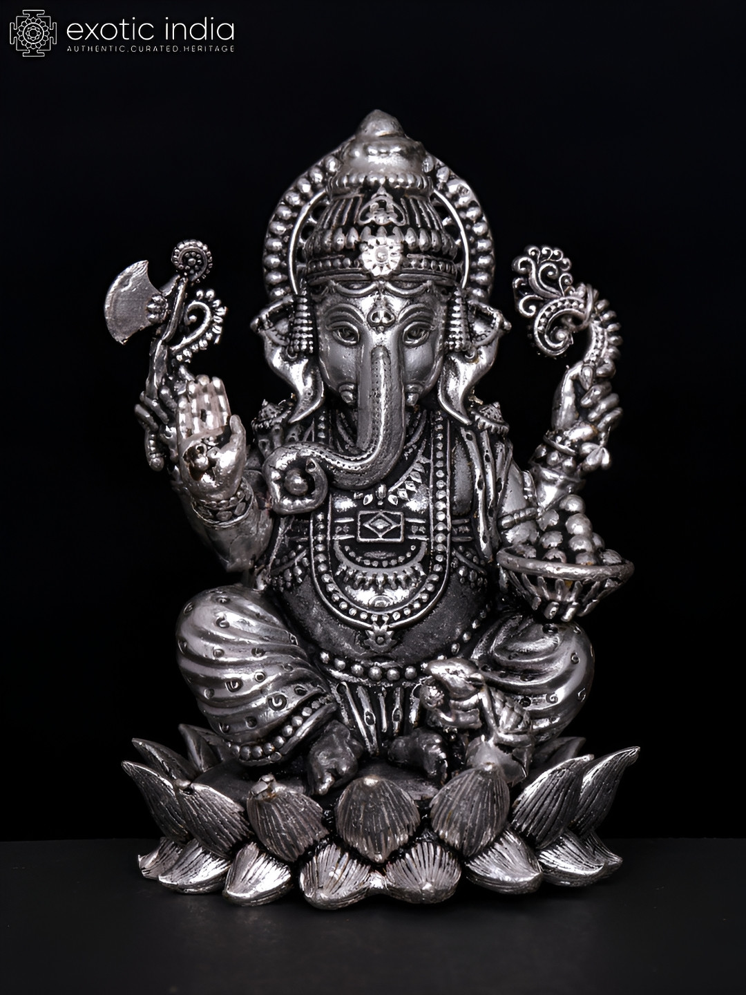 Exotic India Four-Armed Lord Ganesha Seated on Lotus Silver Brass Metallic Prayer Room Tiny Showpiece - 1 Inches