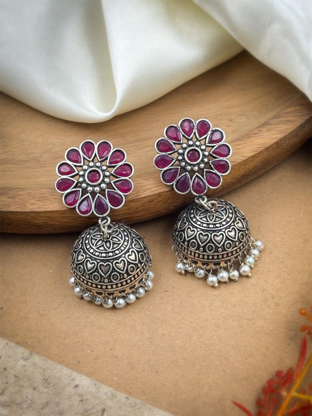 NAMAN ARTS Silver-Plated Artificial Stones Studded & Beaded Dome Shaped Oxidised Jhumkas