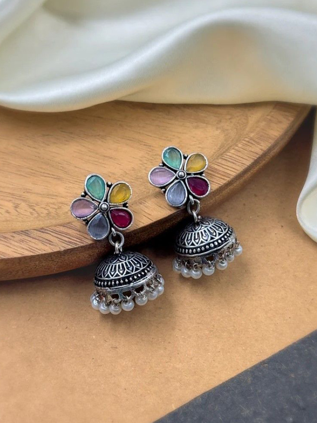 NAMAN ARTS Silver-Plated Artificial Stones Studded & Beaded Dome Shaped Oxidised Jhumkas