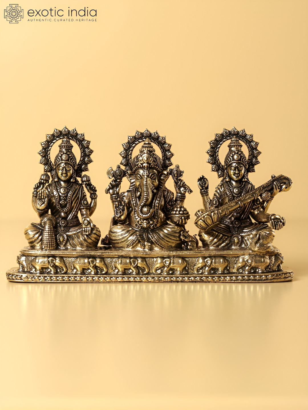 Exotic India Goddess Lakshmi, Saraswati and Lord Ganesha Gold Brass Metallic Prayer Room Small Showpiece - 3.1 Inches