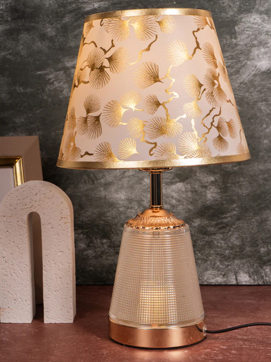 Golden Table Lamp With Fusion Of Modern Design  Fiberglass  Frustrum Shaped Matelic Base