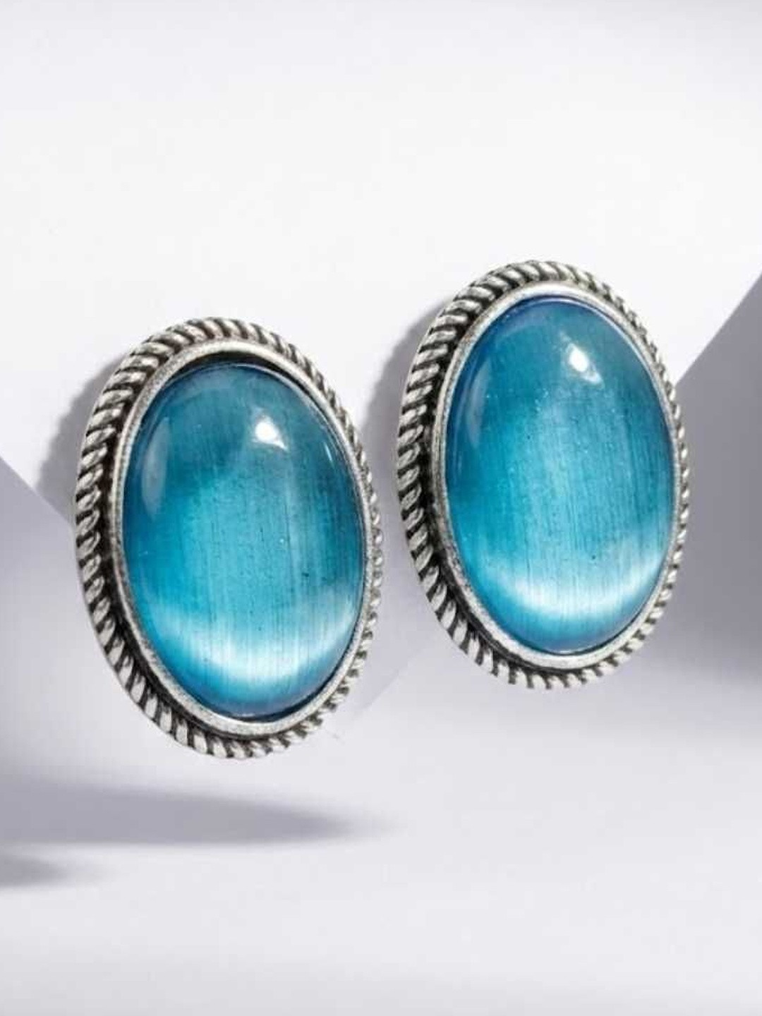 BANITHANI Silver-Plated Artificial Stones Studded Oval Shaped Earrings