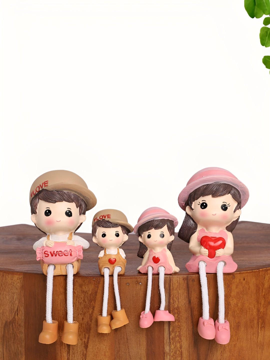 INTERNATIONAL GIFT Family with Dangling Legs Pink Polyresin Natural Living Room Set of 4 Small Showpieces - 1.6 Inches