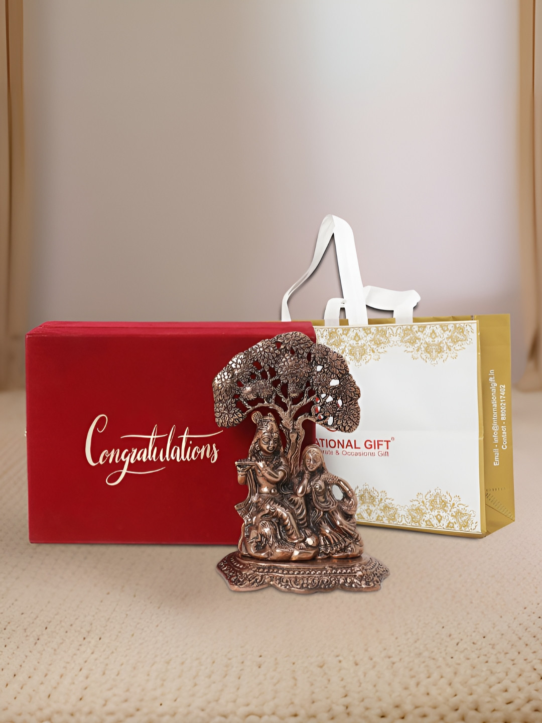 INTERNATIONAL GIFT Radha Krishna with Box, Bag and 'Congratulations' Personalized Tag Brown Metal Metallic Prayer Room Medium Showpiece - 7 Inches