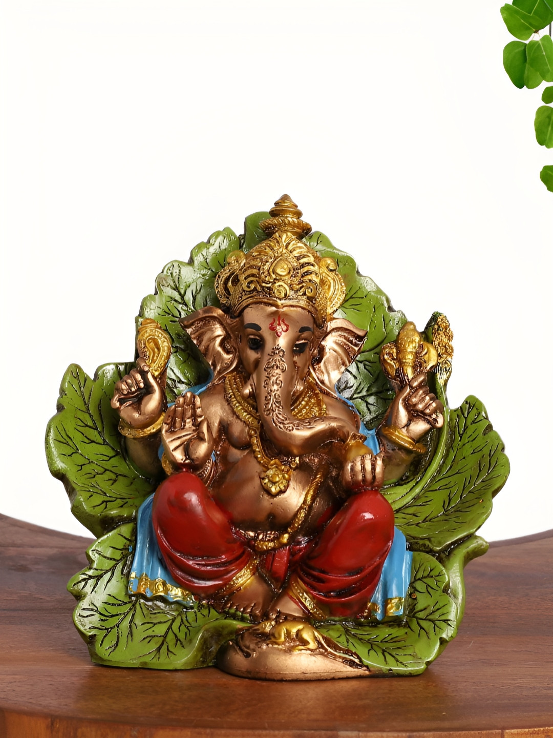 INTERNATIONAL GIFT Lord Ganesha on Leaf Backrest Gold Polyresin Metallic Prayer Room Small Showpiece - 2.5 Inches