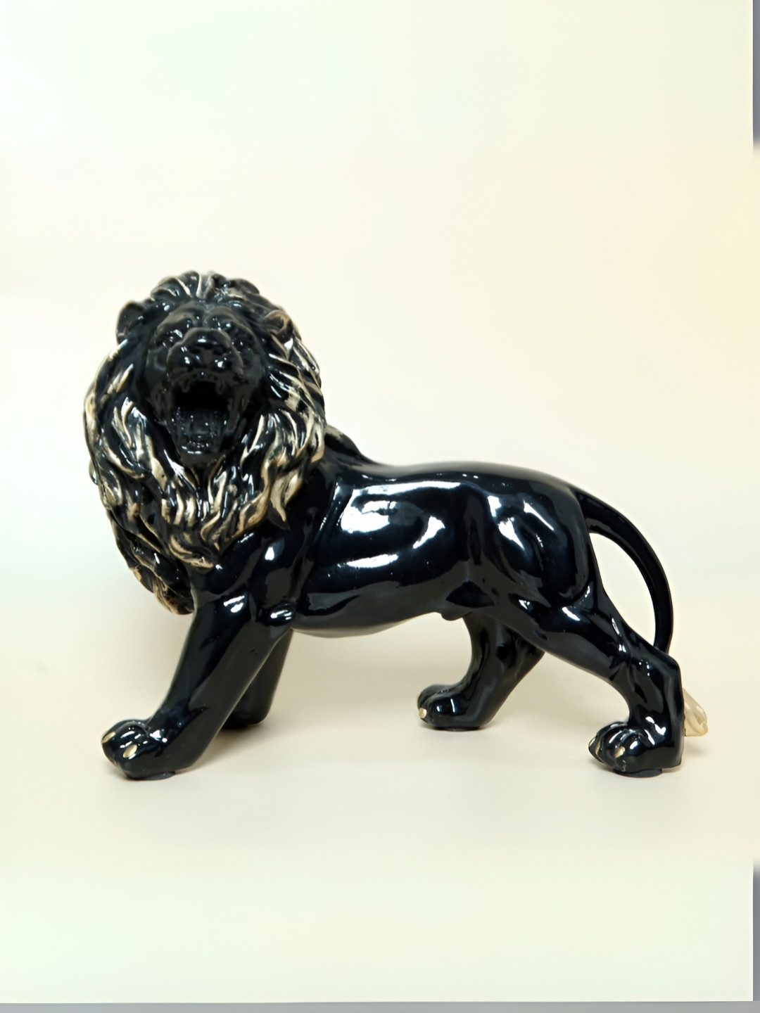 SMOKEY COCKTAIL Black & Gold-Toned Bold Lion Figurine Showpiece