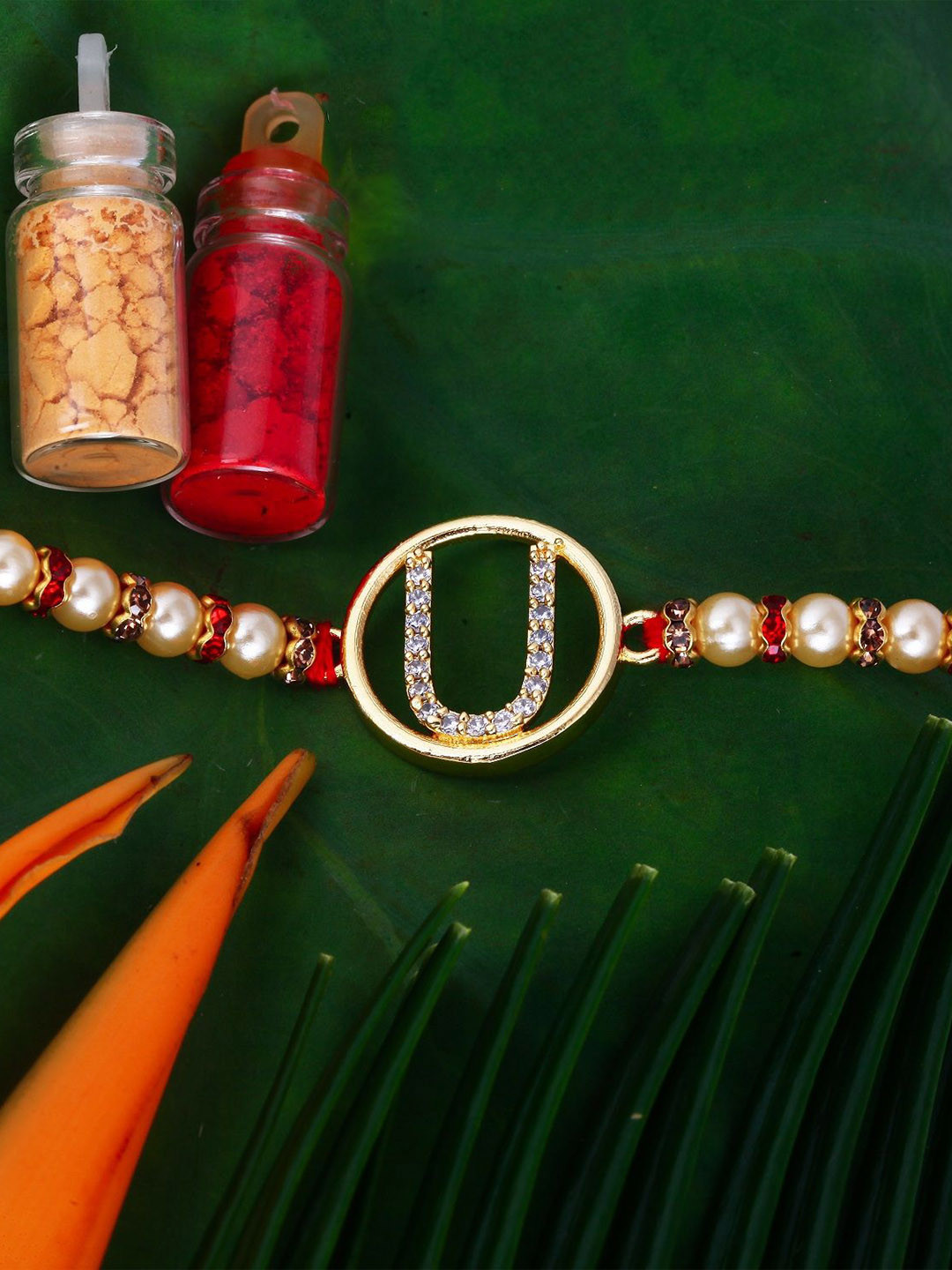 Vighnaharta Gold Plated Cubic Zirconia Studded U Alphabet Thread Rakhi