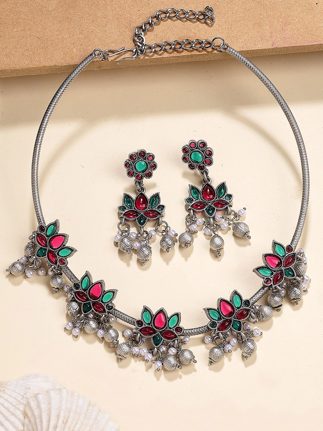 KARATCART Oxidized Silver Lotus Design Hasli Necklace with Red and Green Stones for Women