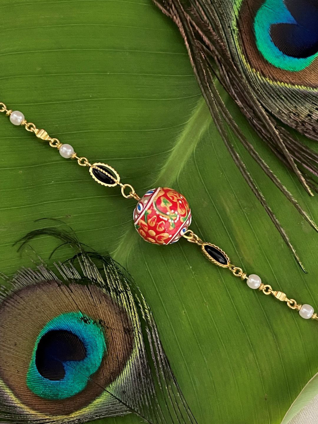 Digital Dress Room Gold-Plated Stones Studded & Pearls Beaded Red Ball Lumba Rakhi