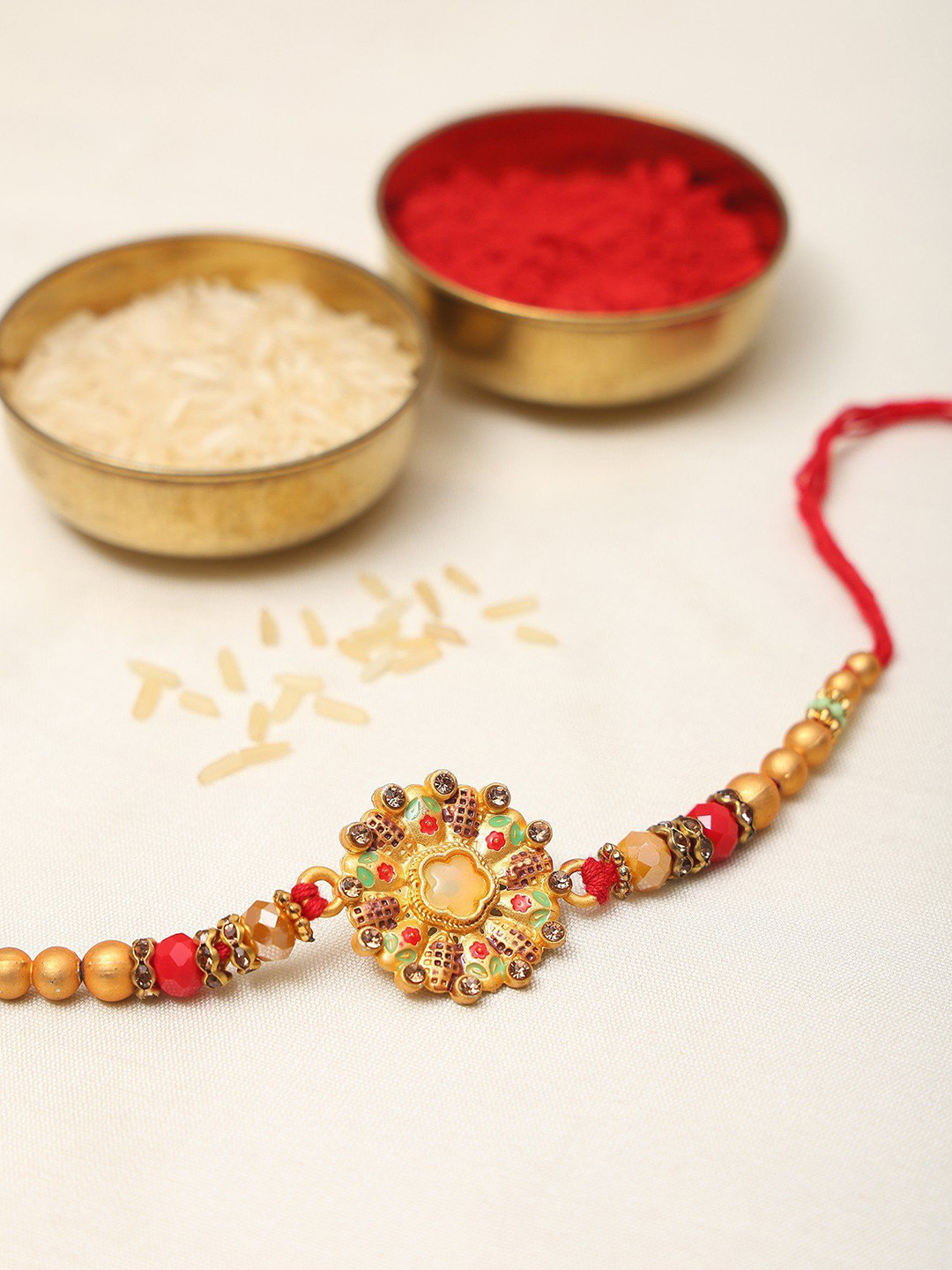 Exotic India Stone Studded & Beaded Floral Round Enamel Work Thread Rakhi
