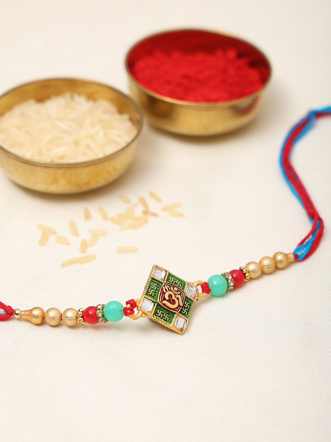 Exotic India Stone Studded & Beaded Traditional Kite Shaped Om Shubh Thread Rakhi